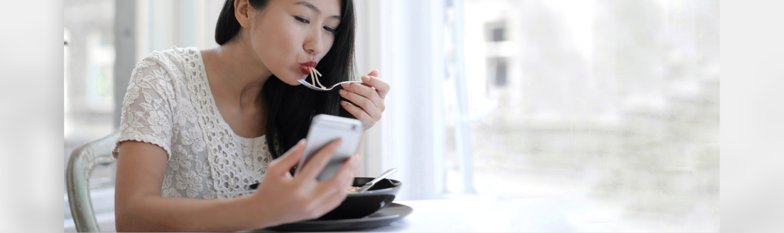 Girl eating while using her phone